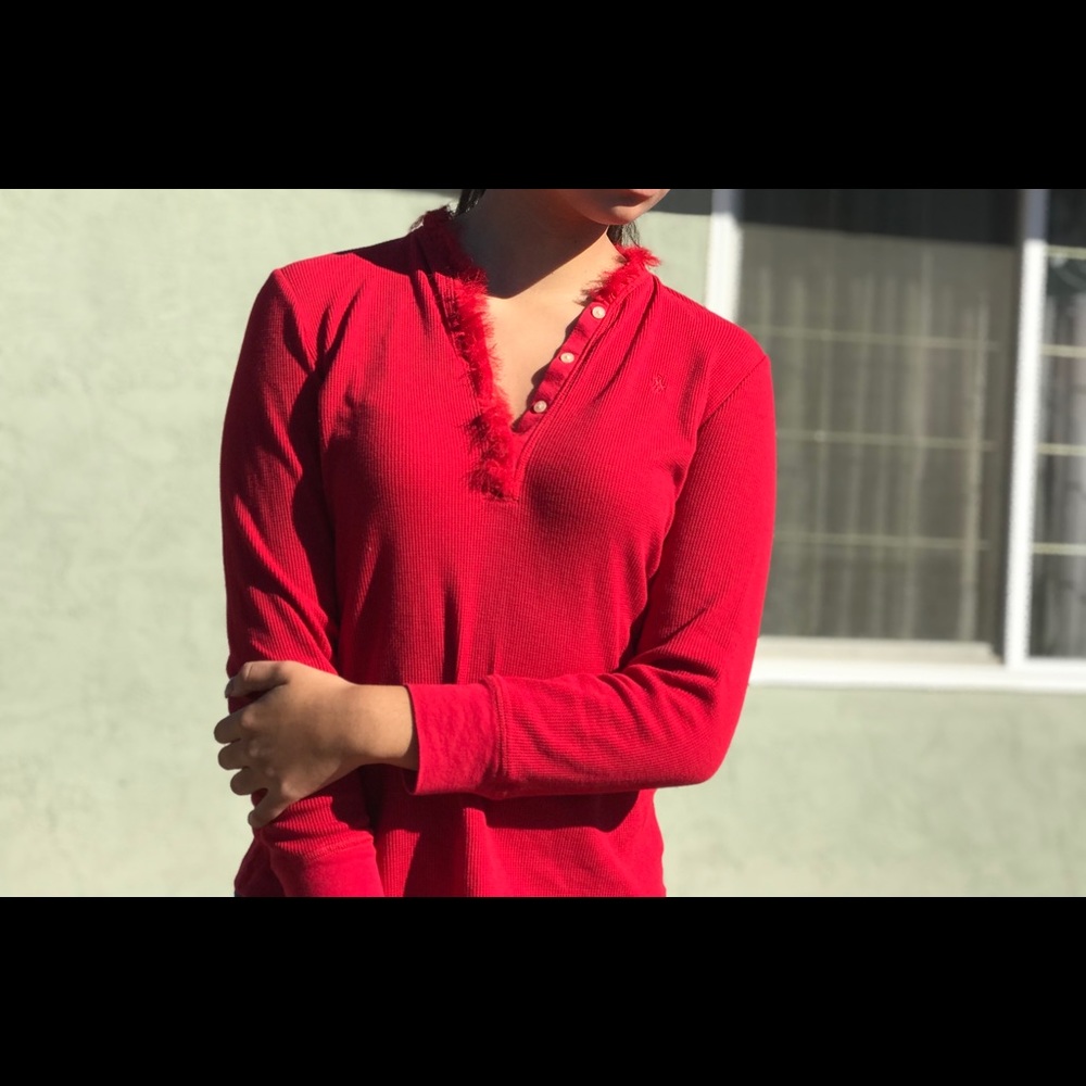 Long sleeved red shirt with fur around the collar.